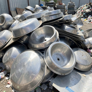 Pile of old stainless steel sinks and scrap metal sheeting for recycling at Copper Plus Recycling Marrickville
