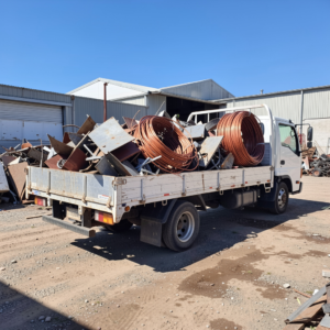White flatbed scrap truck transporting sorted scrap metal at Copper Plus Recycling Marrickville